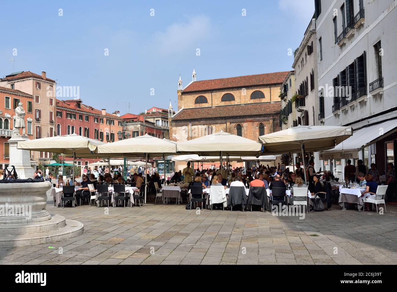 VENICE, ITALY - SEPT 21, 2014: People visit street cafe on square S. Stefano in Venice. This is the typical Venetian cafe Stock Photo