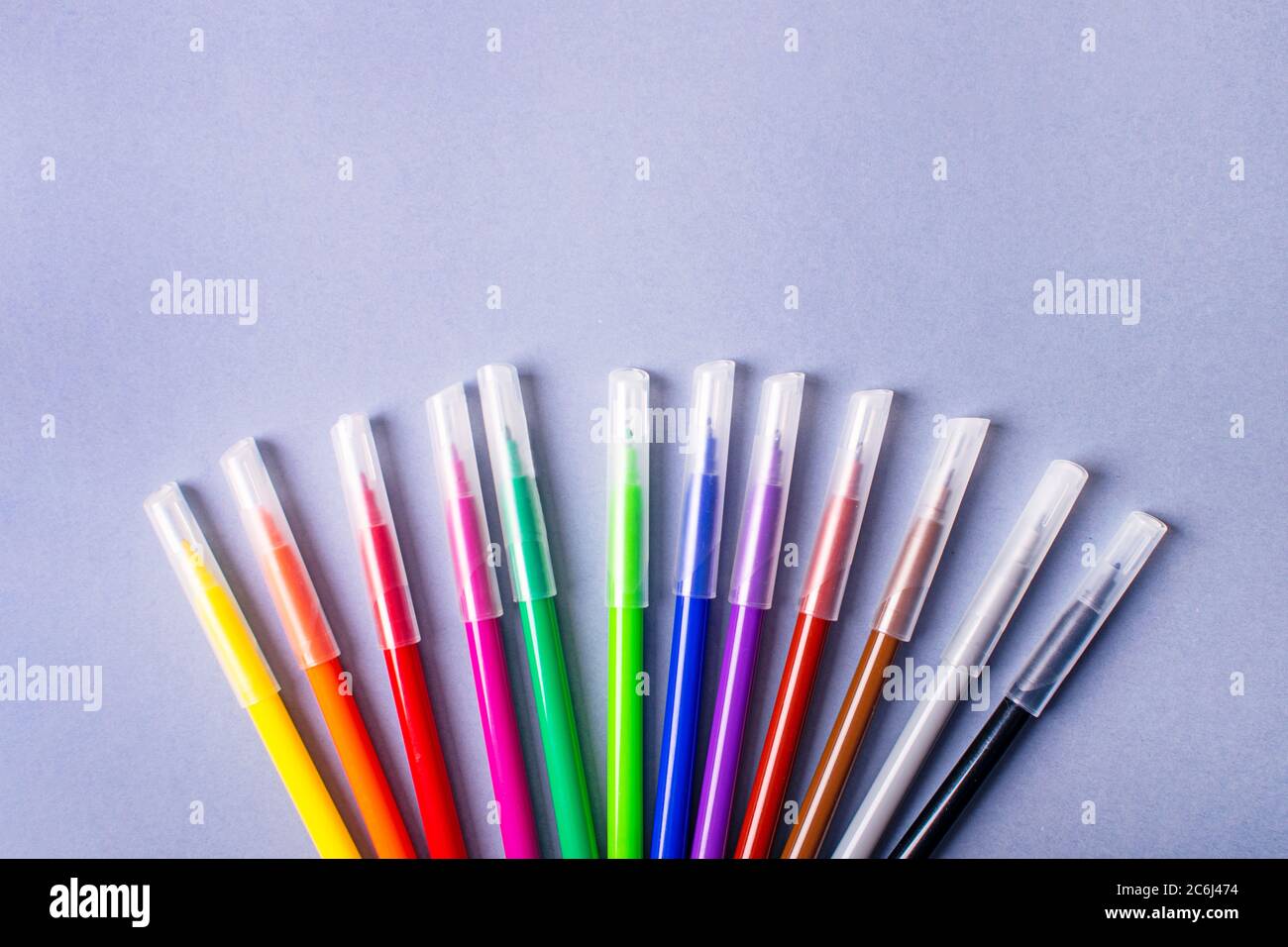 Multicolored felt-tip pens or markers on gray background. Stock Photo