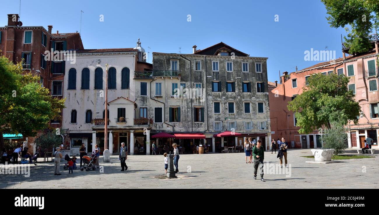 VENICE, ITALY - SEPT 22, 2014: Campo del Ghetto Novo. Central square in Jewish Ghetto. Tourists from all the world enjoy the historical city of Venezi Stock Photo