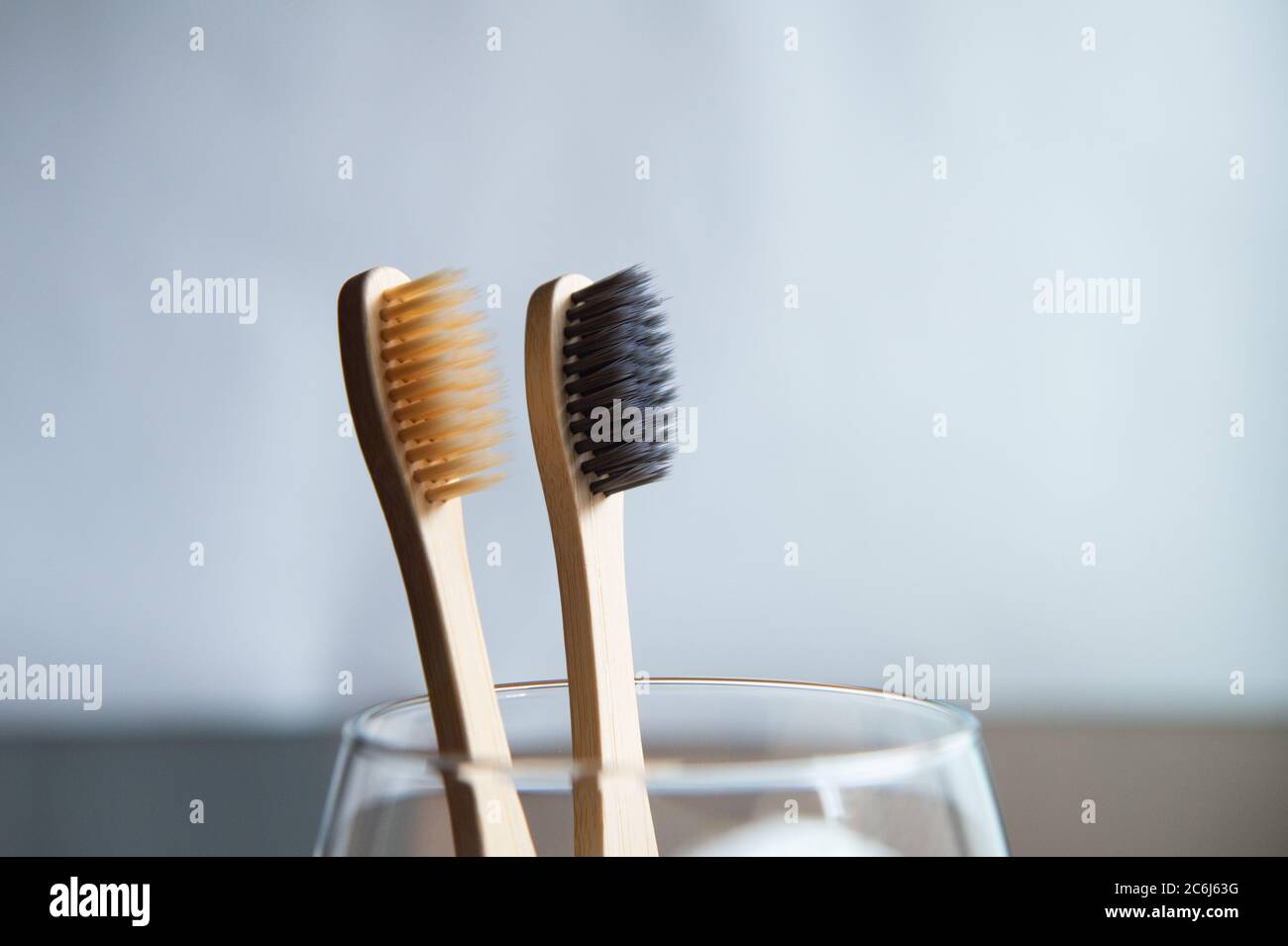 Toothbrushes in glass on blurred background Stock Photo