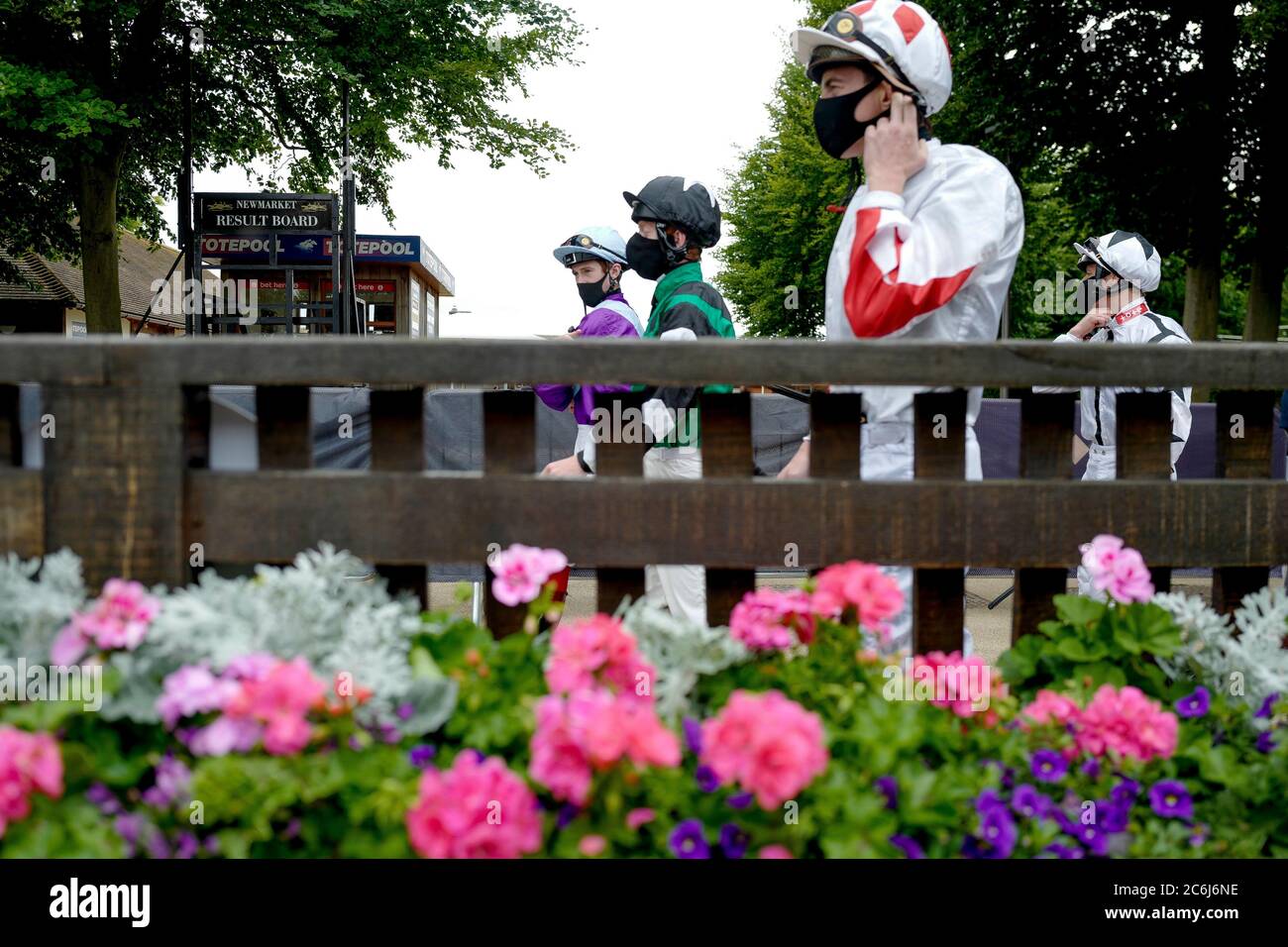 A general view as jockeys make their way to the parade ring during day two of The Moet and Chandon July Festival at Newmarket Racecourse. Stock Photo