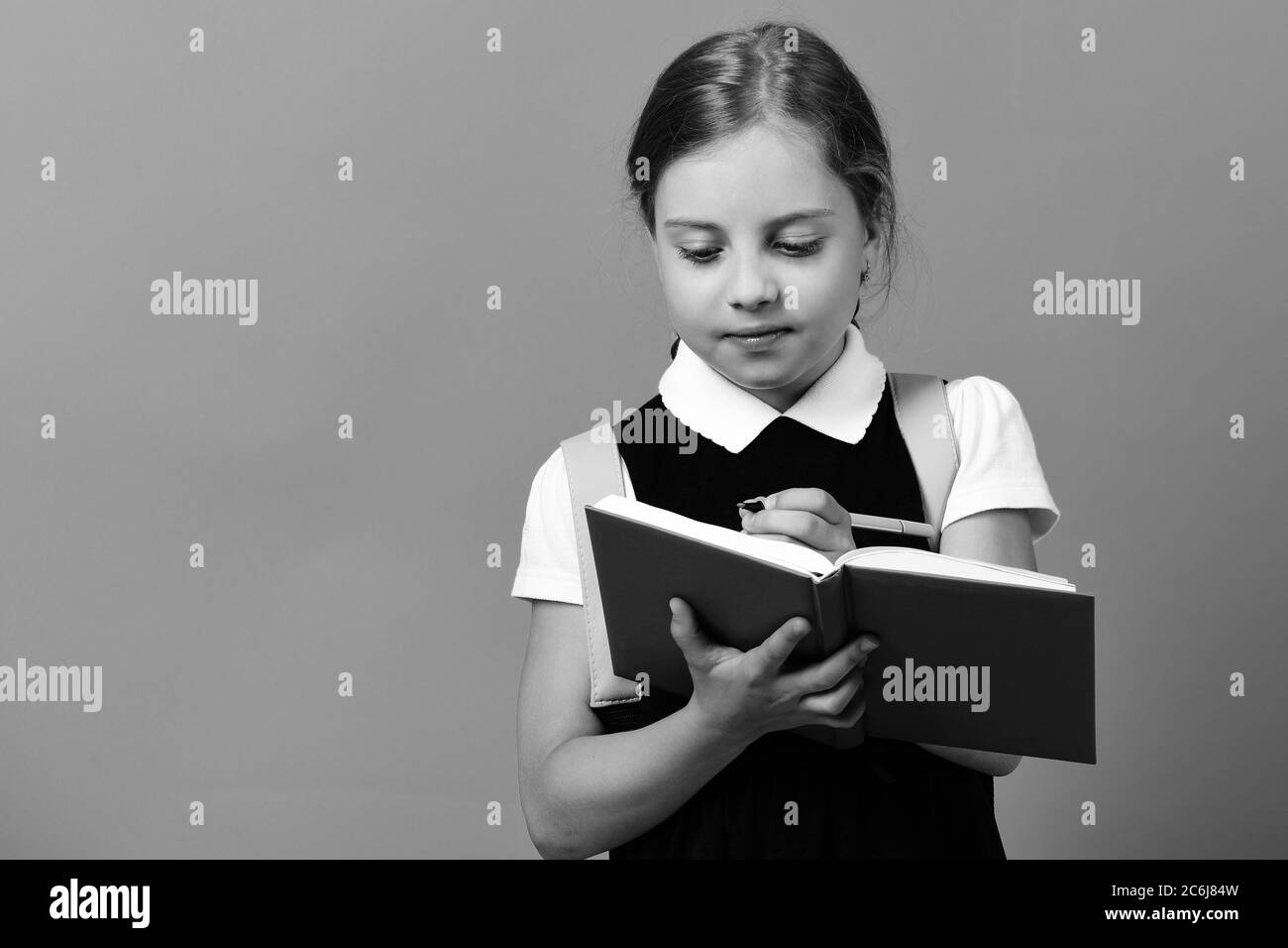 School girl with attentive face expression on blue background. Girl ...
