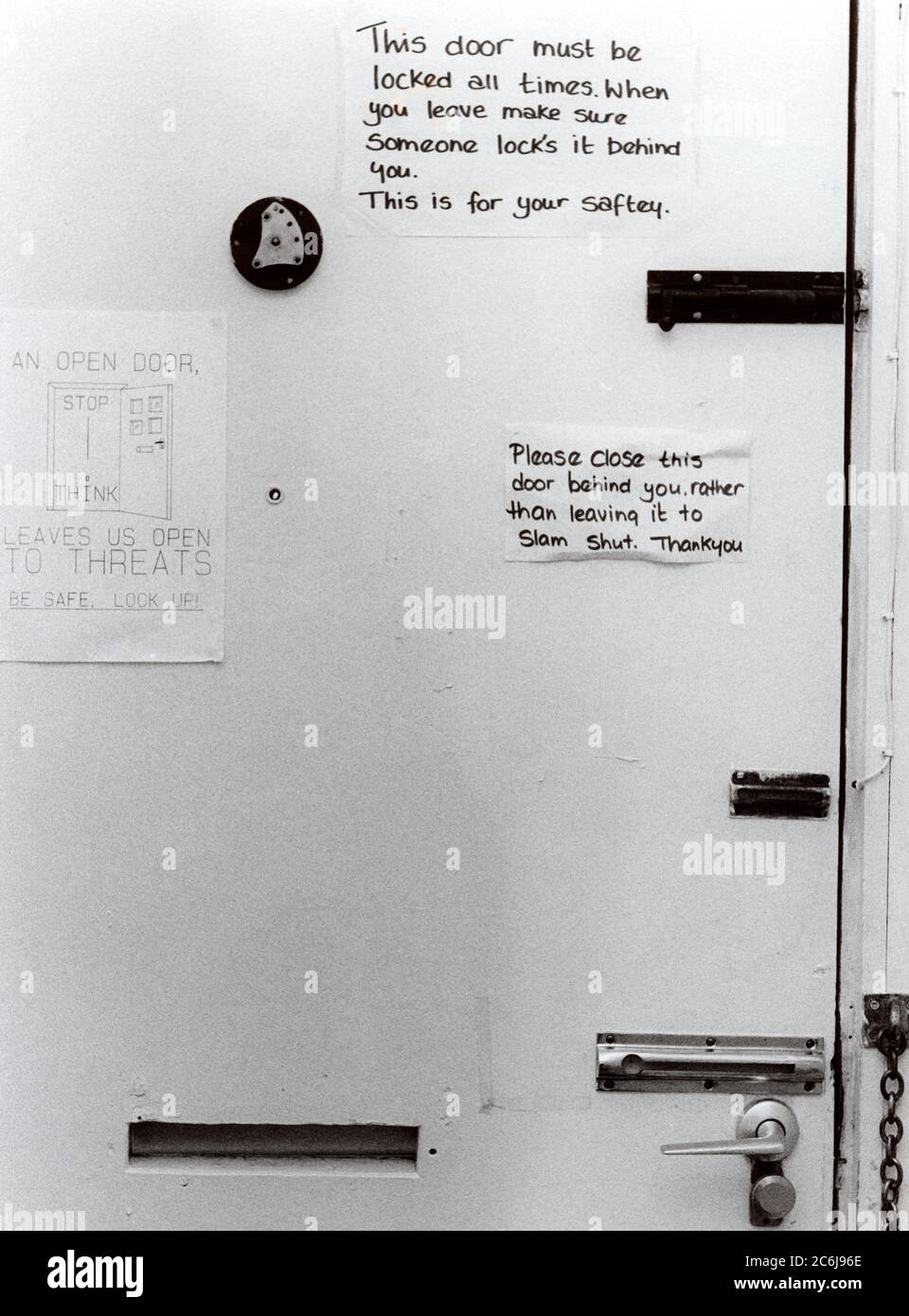 Women's refuge for battered women,  Warning & safety notices on front door; Leeds, UK Stock Photo