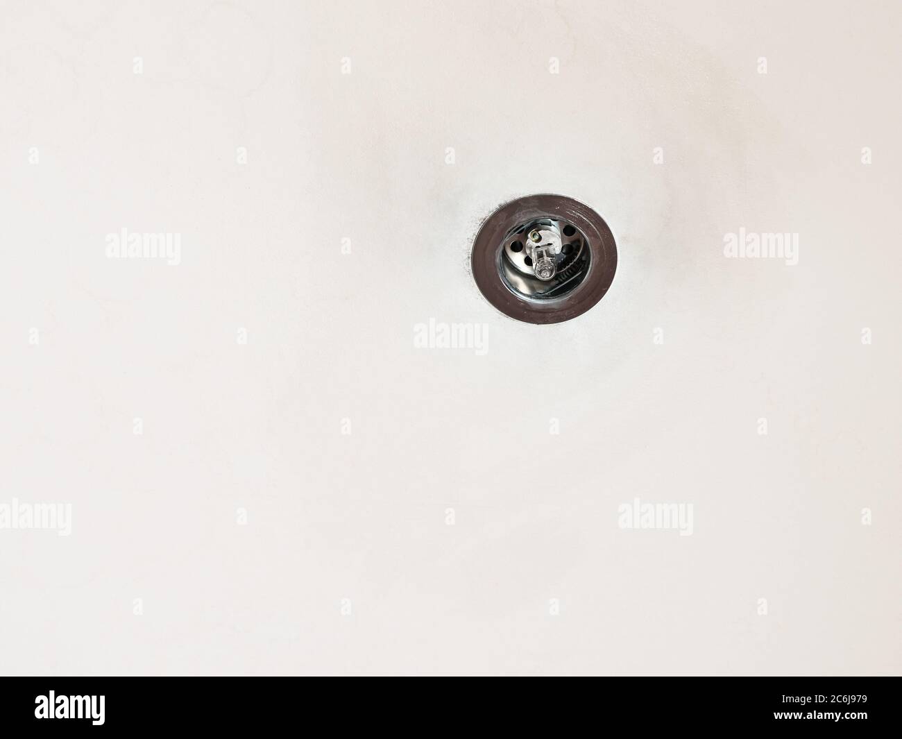 used halogen lamp mounted in old plasterboard false ceiling Stock Photo