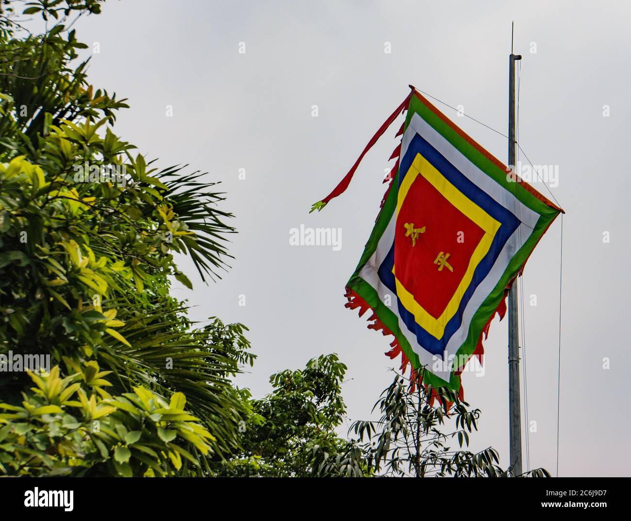 Vietnamese Buddhist Temple flags with the 5 symbolic colors Stock Photo