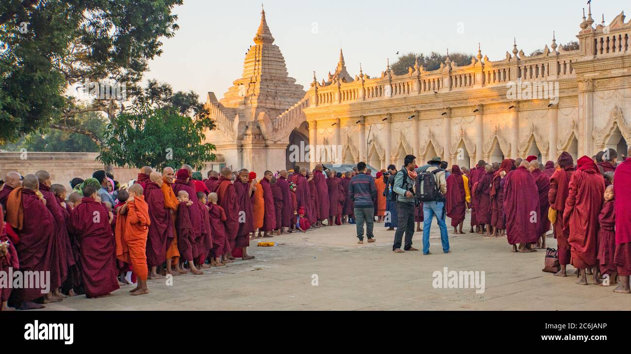 Bagan/Myanmar - January 19,2019:  monks lining up to honor the pilgrims that have  donated alms to them at the annual festival at the Ananda Monastery Stock Photo