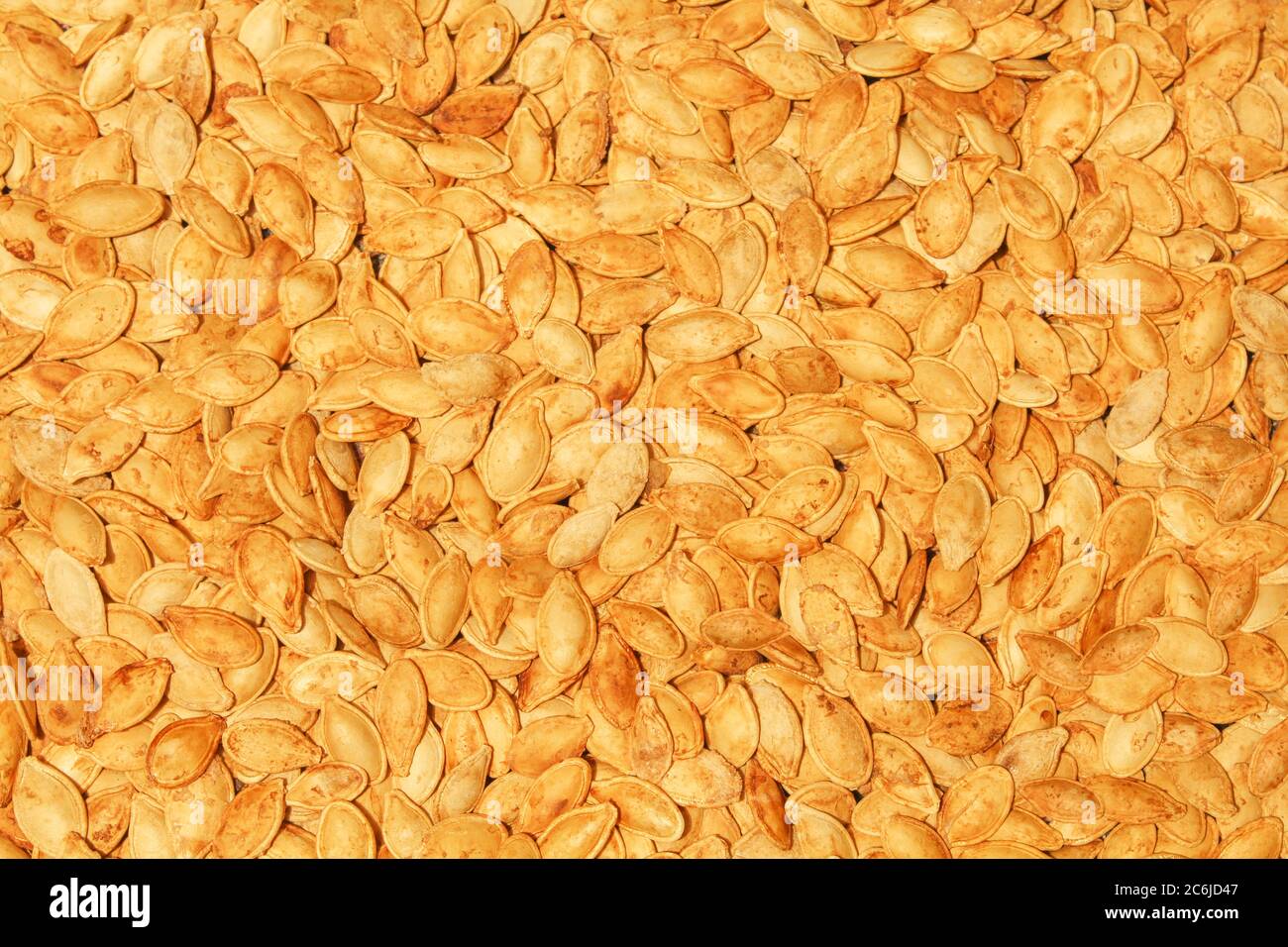 Fried and salty pumpkin seeds. Flat lay of roasted home cooked food Stock Photo