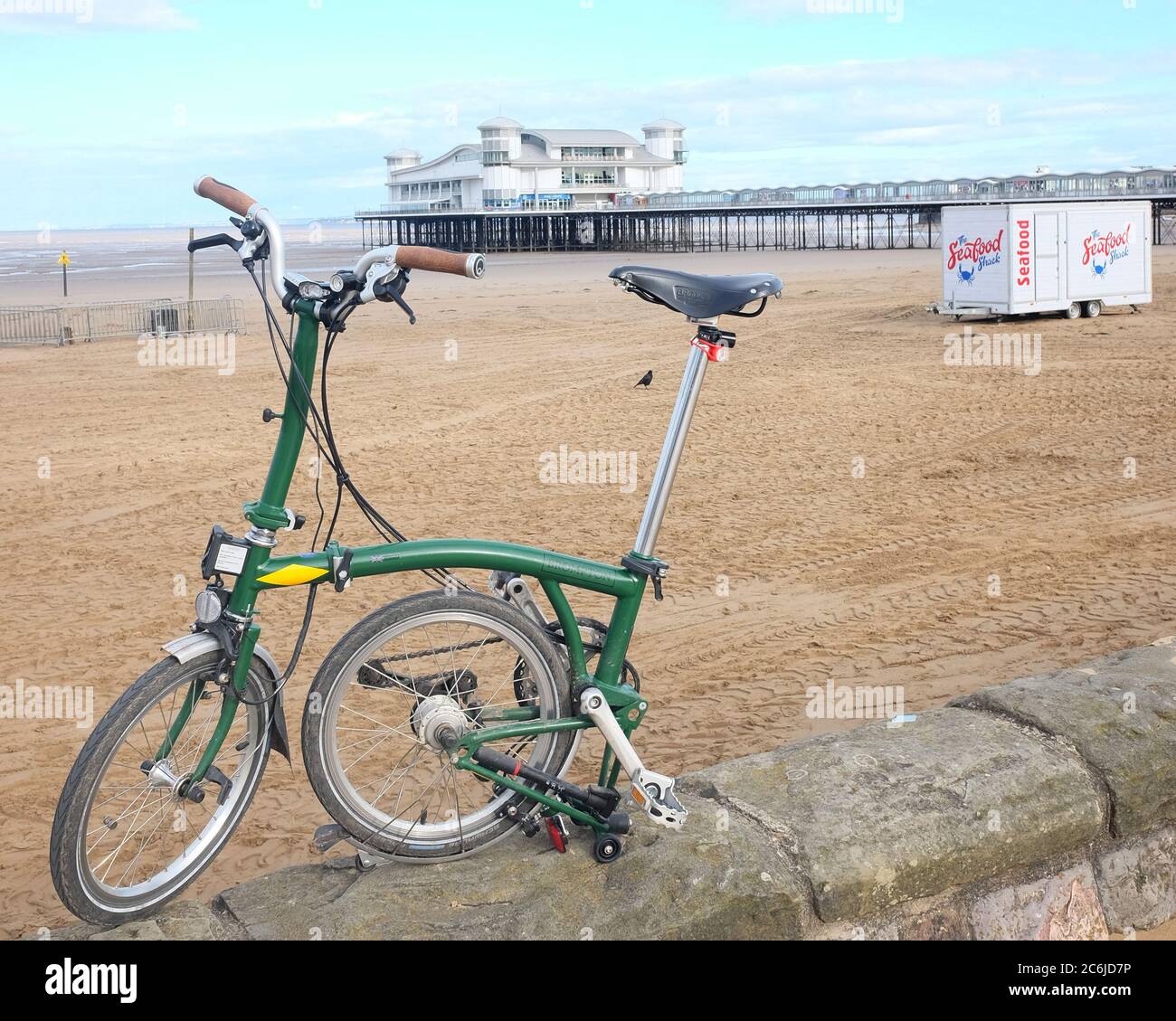 July 2020 - Brompton folding bike in front of the Weston super Mare pier. Stock Photo