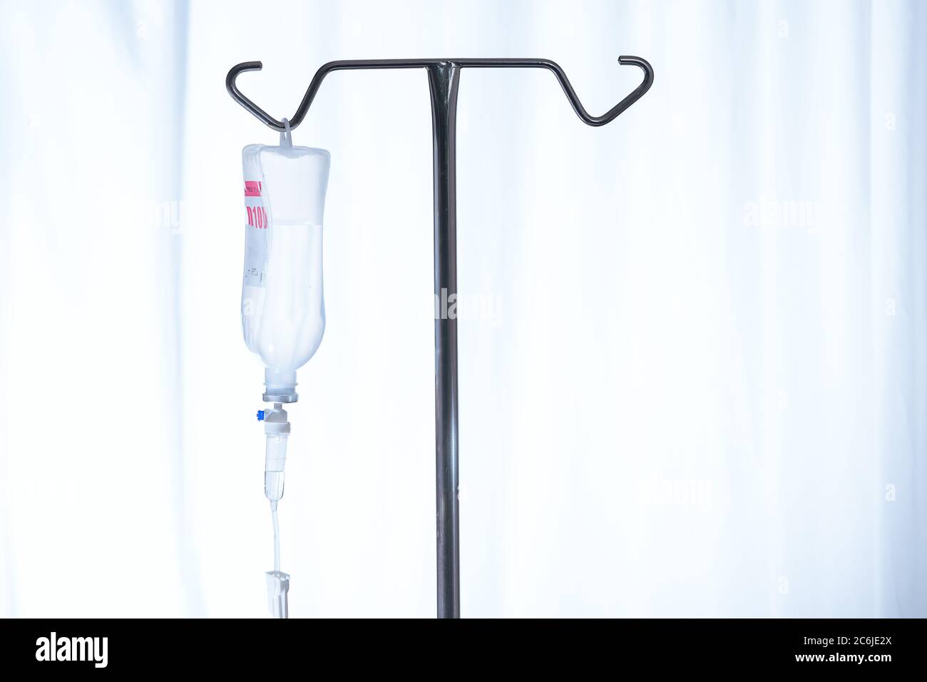 Close up saline IV drip Infusion bottle with IV solution for patient in ward hospital Stock Photo
