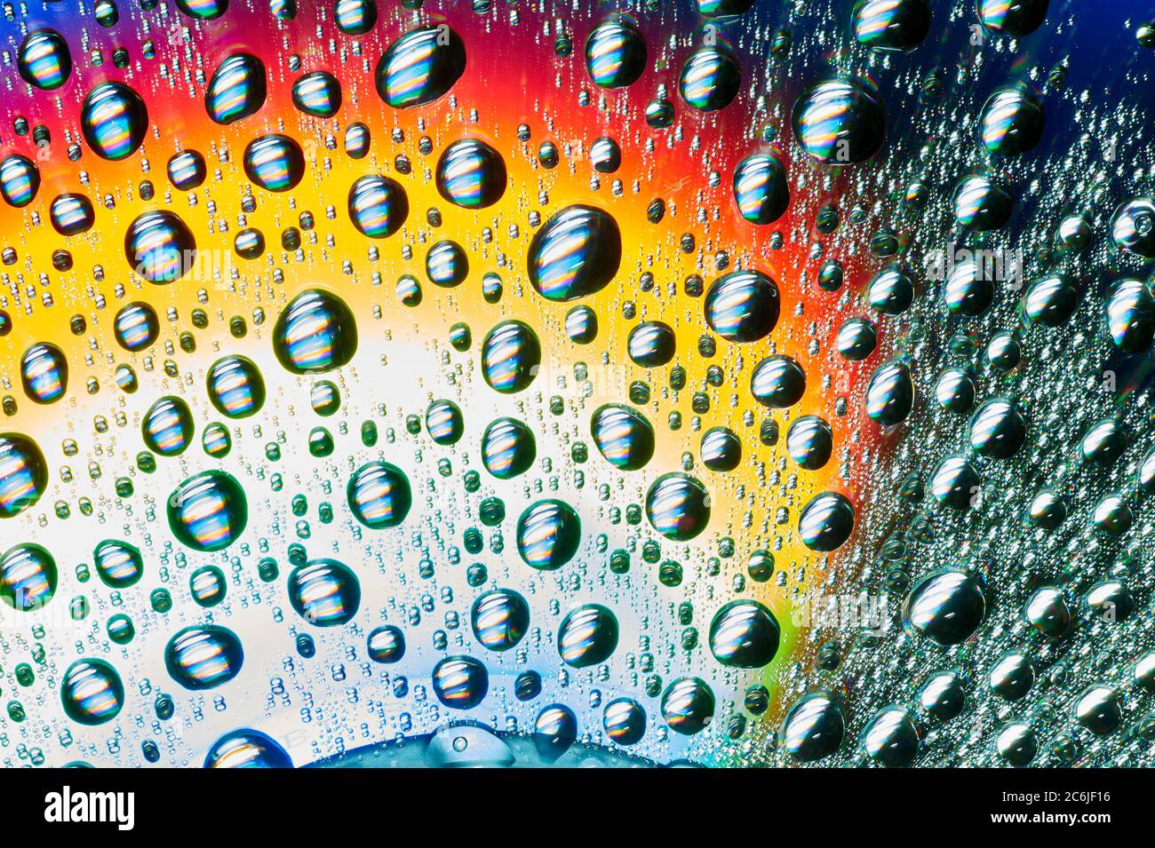 Macro of water drops on multicolor background Stock Photo - Alamy
