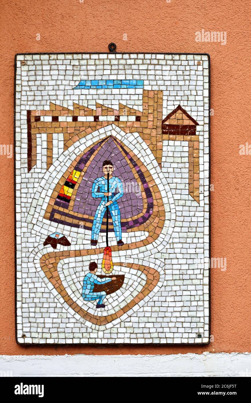 MURANO ISLAND, ITALY - SEPT 26, 2014: Colorful mosaic on the street of Murano. Craftsman - glassblower making glassware - symbol of independence of th Stock Photo