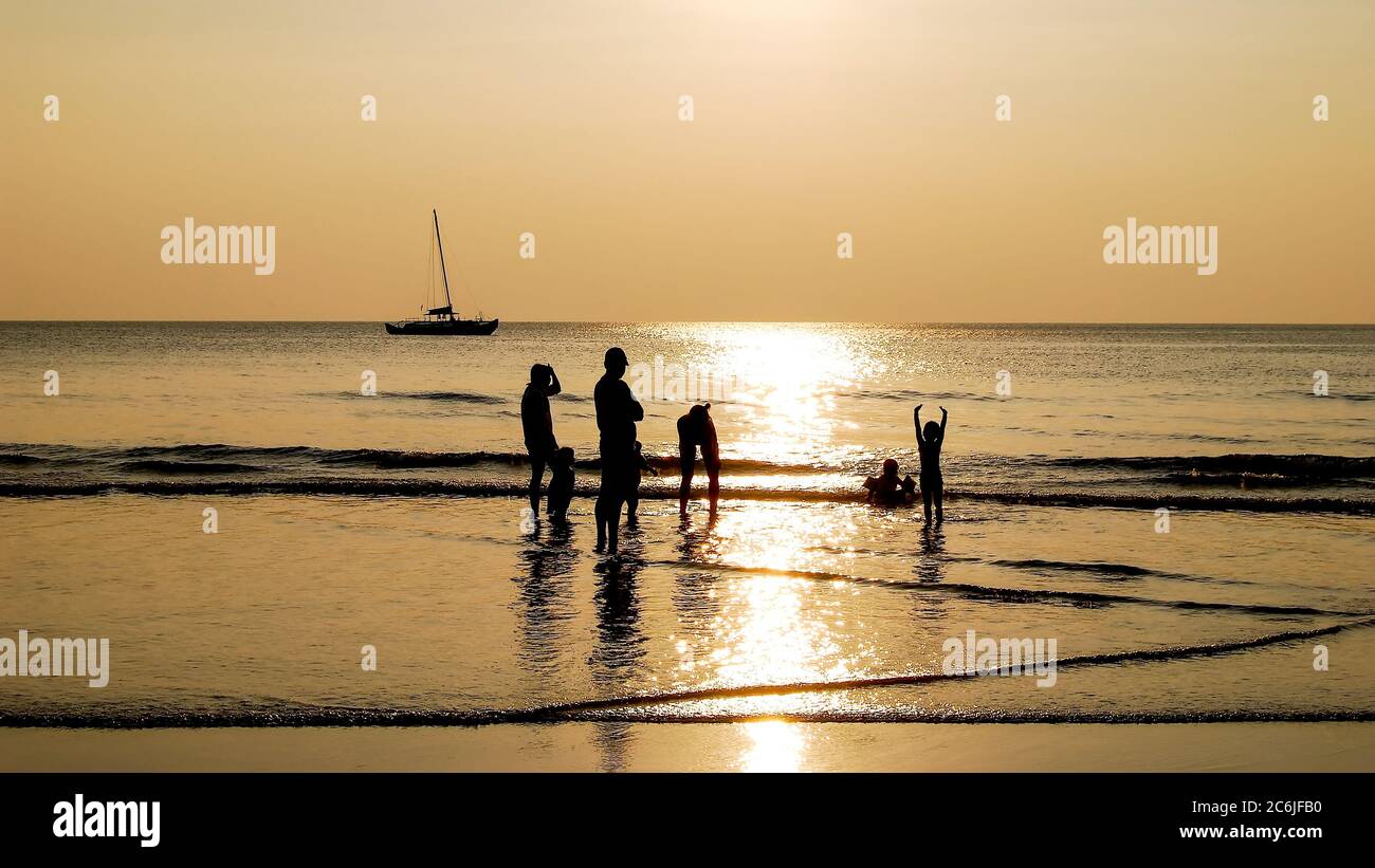 The family welcomes the sunset on the beach. Thailand. Ko Chang Stock Photo