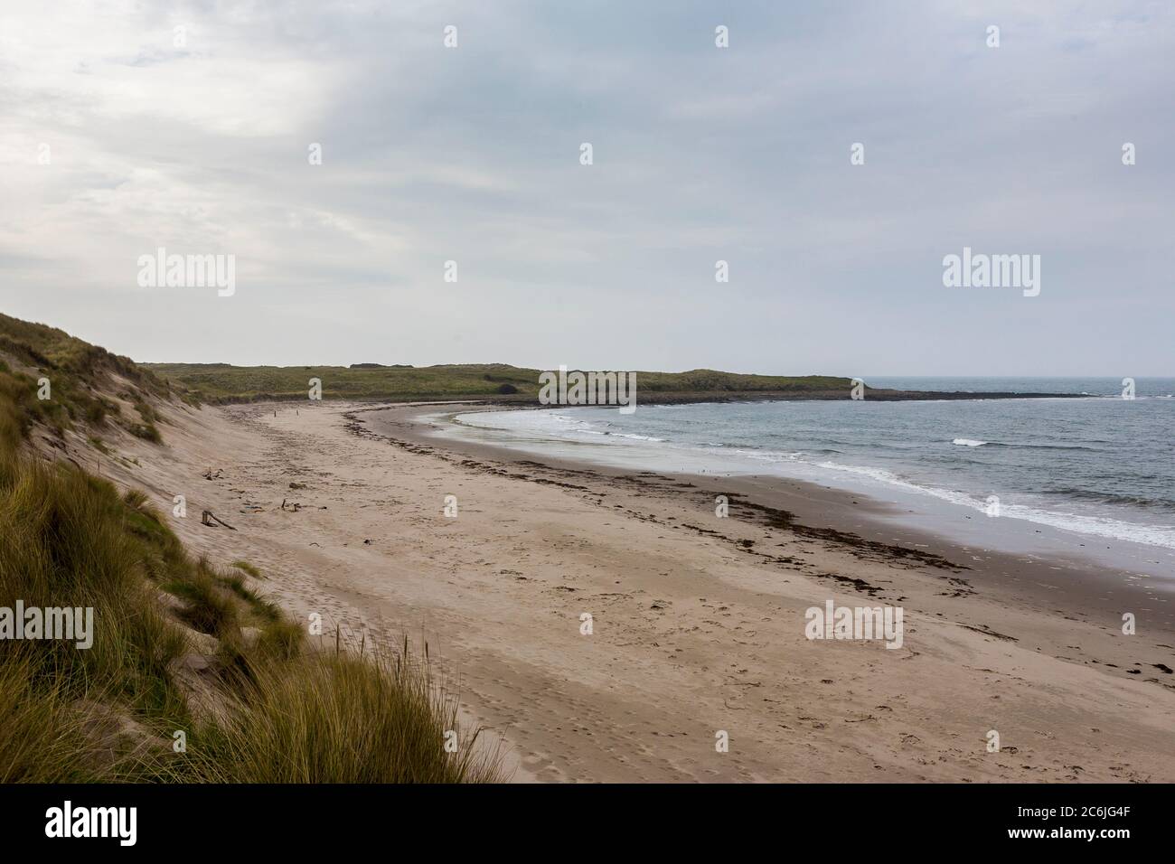 A rather desolate and empty North Sea beach: Sandham Bay, Holy Island of  Lindisfarne, Northumberland, England, UK Stock Photo - Alamy