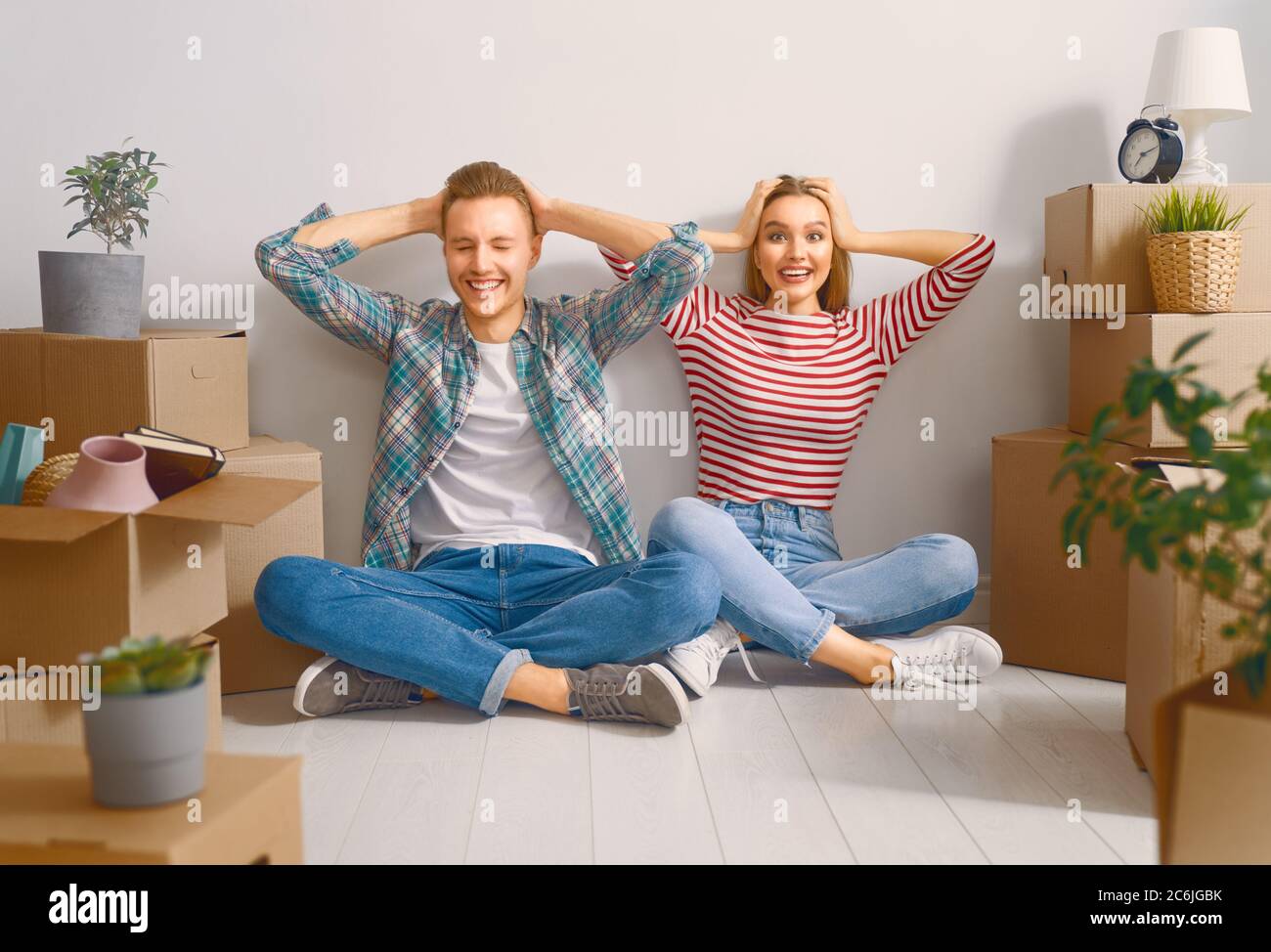 Happy young married couple are moving to new apartment Stock Photo - Alamy
