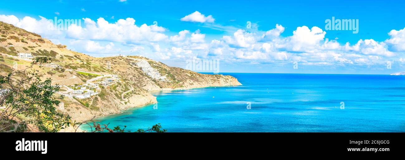 Beautiful Panorama with turquoise sea. View of Theseus Beach, Ammoudi, Crete, Greece. HD landscape, blue sky and mountains. Stock Photo