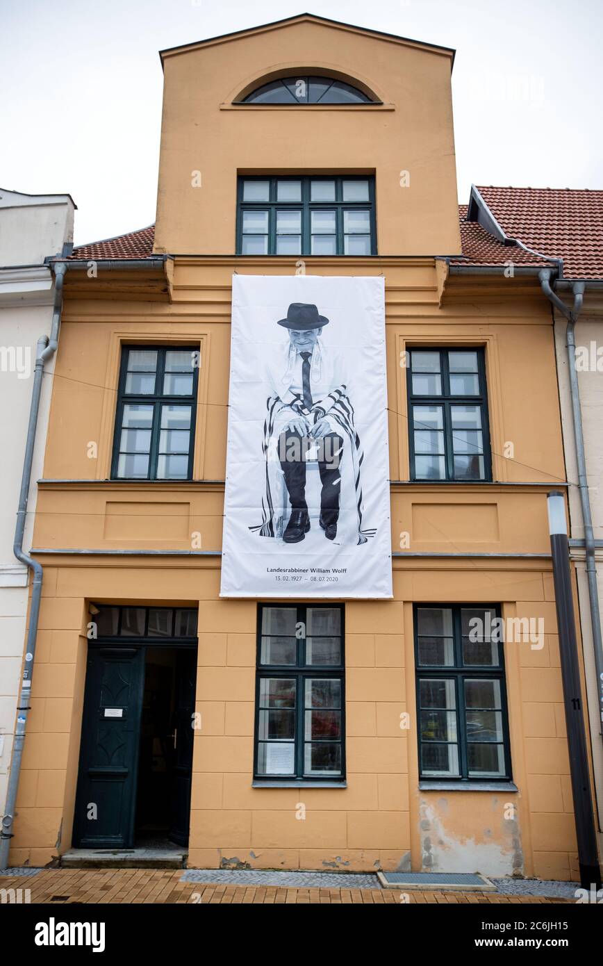 Schwerin, Germany. 10th July, 2020. During a prayer service for the long-time state rabbi in Mecklenburg-Vorpommern William Wolff, a picture of the rabbi by the photographer Koska hangs on the building of the Jewish Community. Wolff had died in England on 08.07.2020 at the age of 93. Credit: Jens Büttner/dpa-Zentralbild/dpa/Alamy Live News Stock Photo