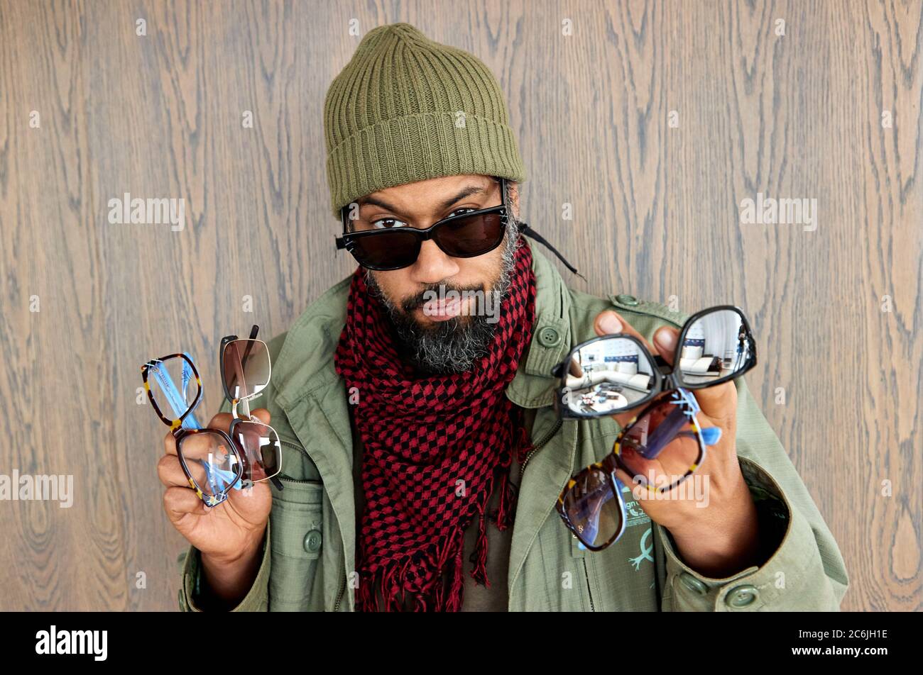 Hamburg, Germany. 10th July, 2020. Rapper Samy Deluxe holds four models of glasses in his hands during the presentation of a new collection of glasses by online optician Edel-Optics. Credit: Georg Wendt/dpa/Alamy Live News Stock Photo