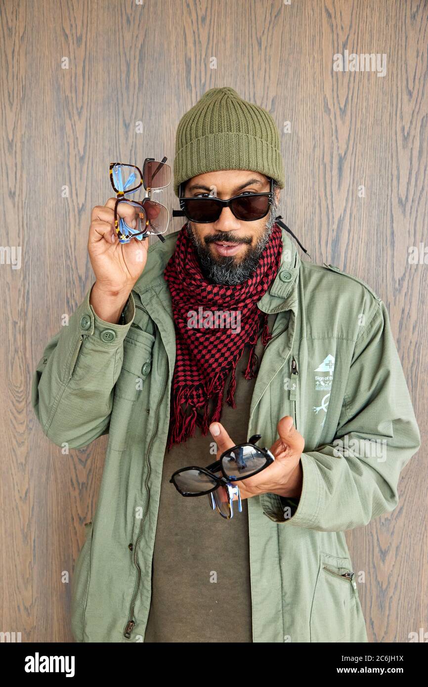 Hamburg, Germany. 10th July, 2020. Rapper Samy Deluxe holds four models of glasses in his hands during the presentation of a new collection of glasses by online optician Edel-Optics. Credit: Georg Wendt/dpa/Alamy Live News Stock Photo