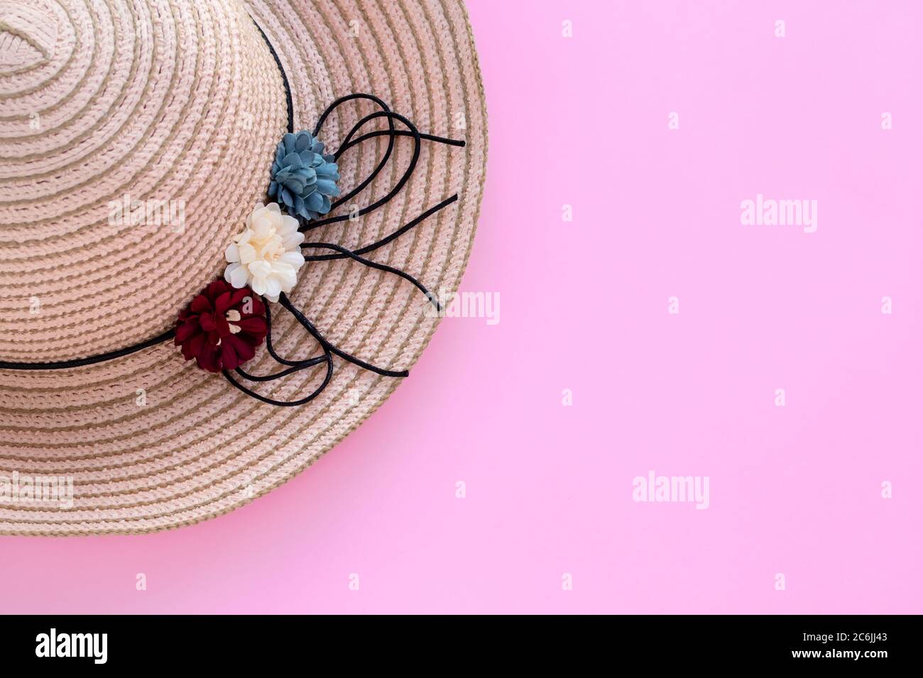 Wicker hat on a pink background, summer vacation, protection concept. Copy space. Empty place for text. Summertime, mockup Stock Photo