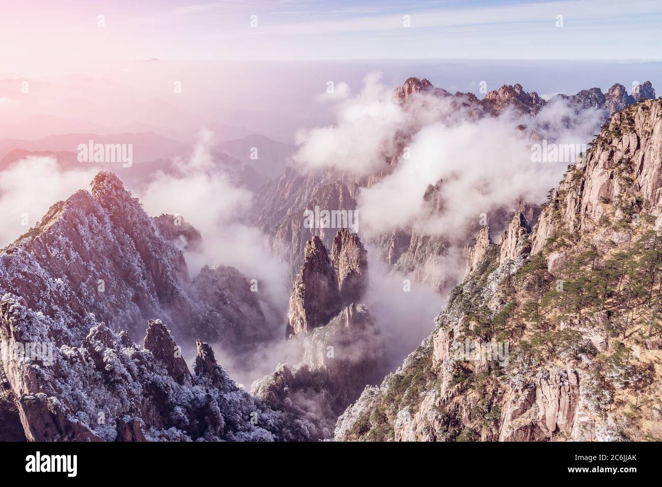 Clouds by the mountain peaks of Huangshan National park at sunrise time ...