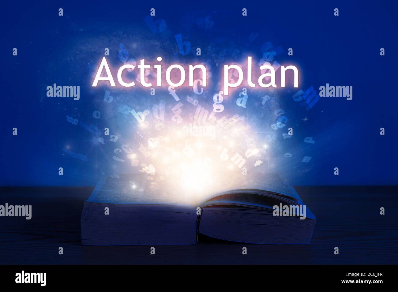 Open book with action plan inscription. Light coming from open book with words action plan. Stock Photo