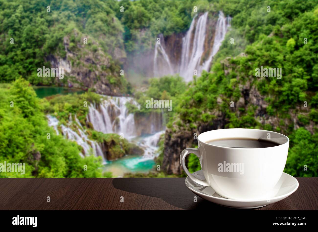 Cup of black coffee or tea with big waterfall background in Croatia ...