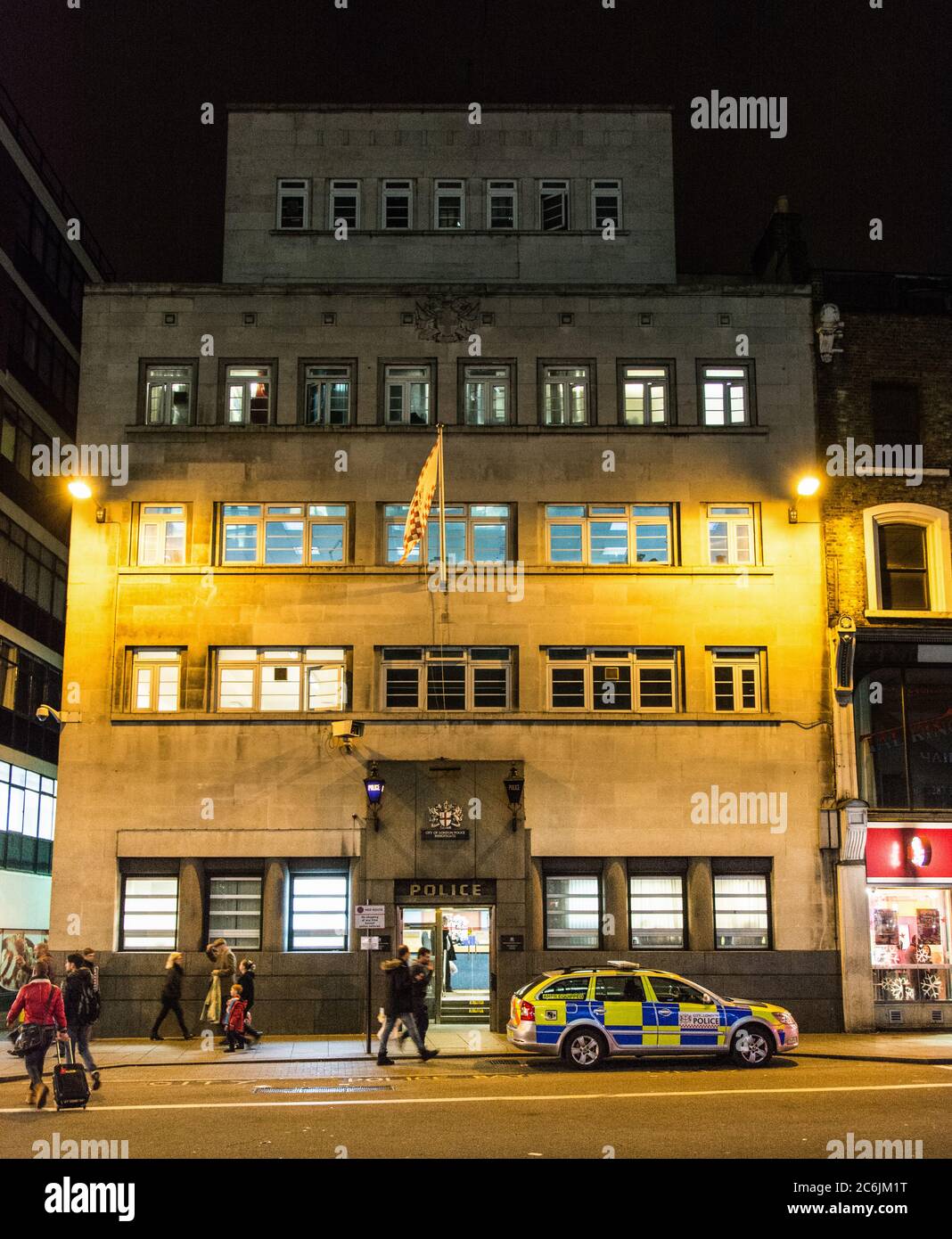 Dusk at Bishopsgate police station with police cars parked outside, London, UK Stock Photo