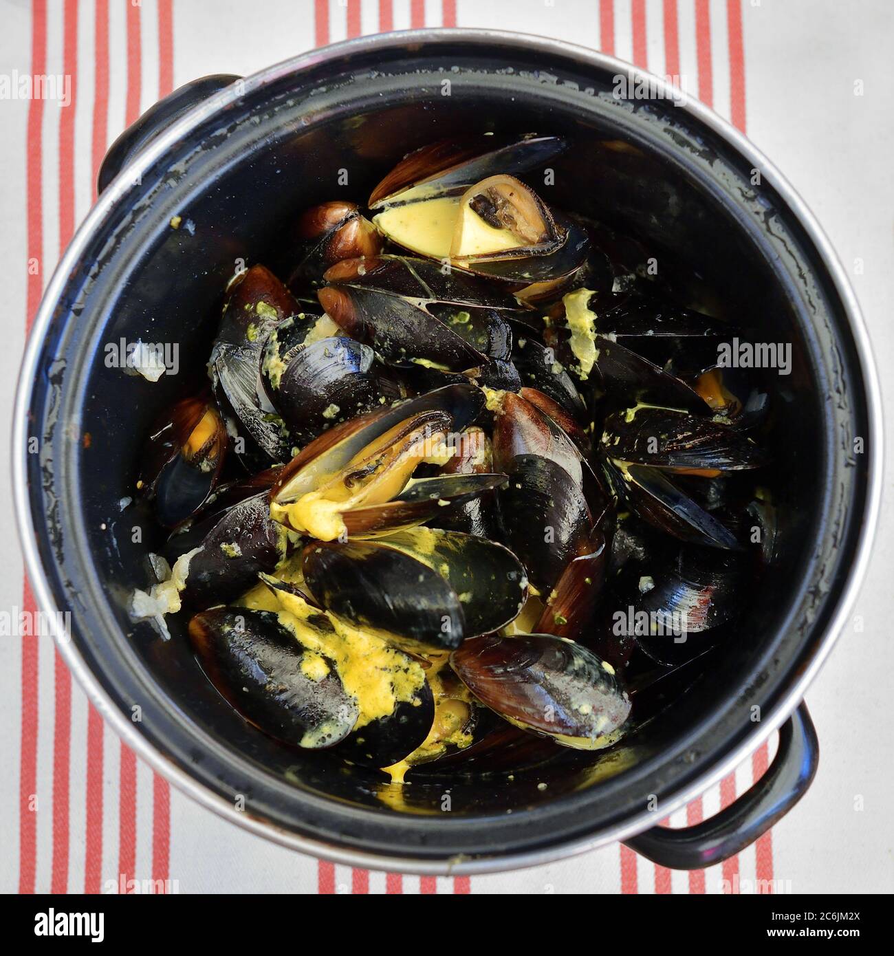Traditional french blue mussel in curry sauce as top view in a pan Stock Photo Alamy