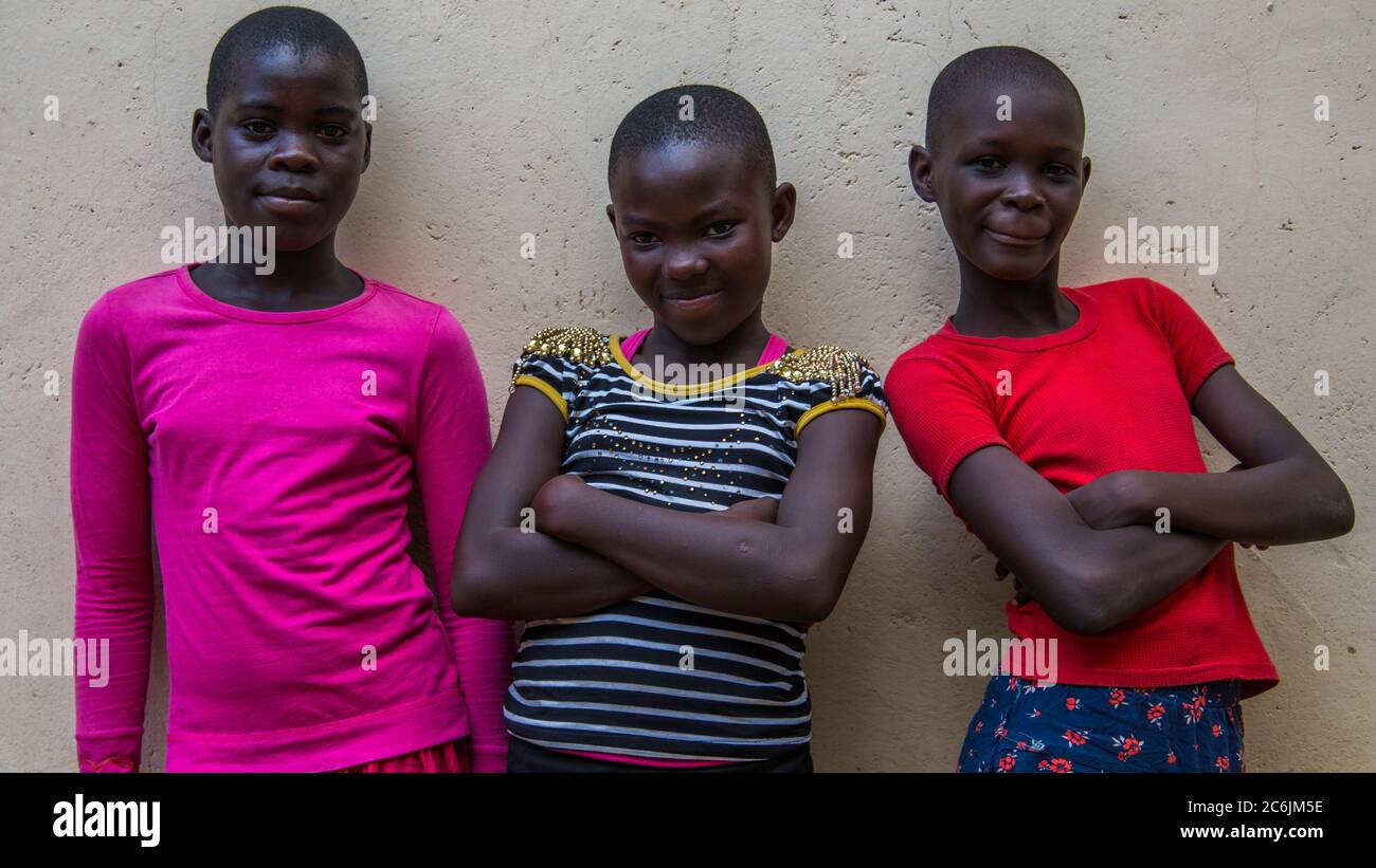 Three girls from Our Lady of Perpetual Hope Catholic School pose for a photo after class ends for the day Stock Photo