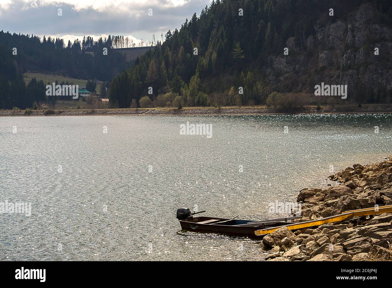 Mountain lake with a small boat in Dedinky, Slovakia. Stock Photo