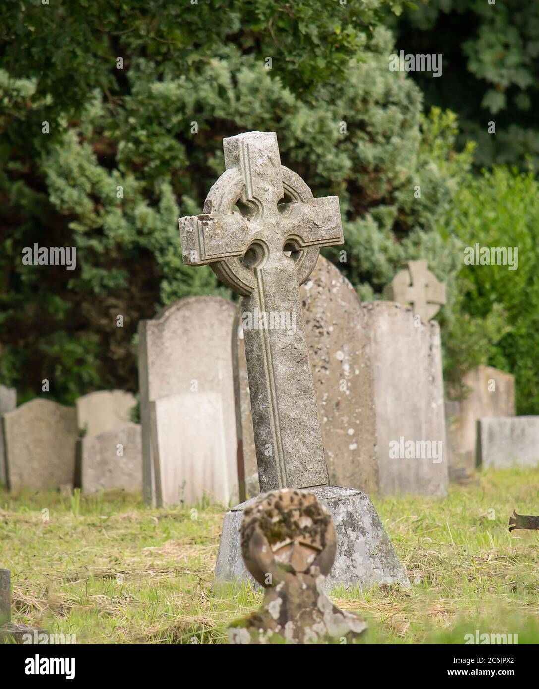 Creepy dark cemetery with old graves. Stock Photo