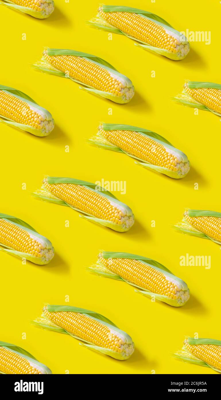 Seamless pattern. ear of fresh corn on yellow background Stock Photo