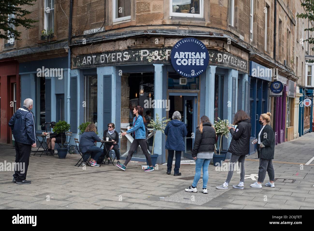 Customers queue outside a coffee shop on Leith Walk, Edinburgh as the restrictions begin to be eased in Scotland during the covid-19 pandemic. Stock Photo