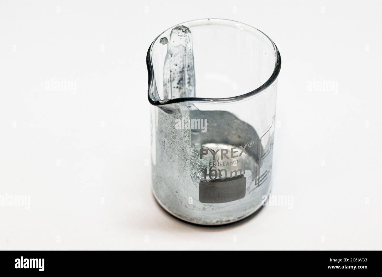 The element Gallium in a glass beaker in the lab. Stock Photo