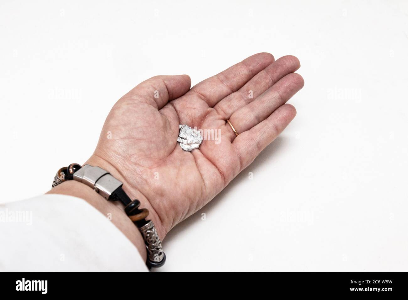The element Gallium melting in a hand in the lab. Stock Photo