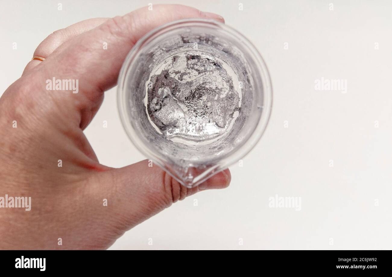 The element Gallium in a glass beaker in the lab. Stock Photo