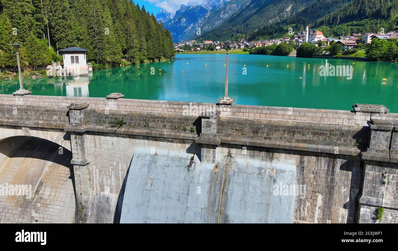 Alpin lake and dam in summertime, view from drone, Auronzo, italian dolomites. Stock Photo