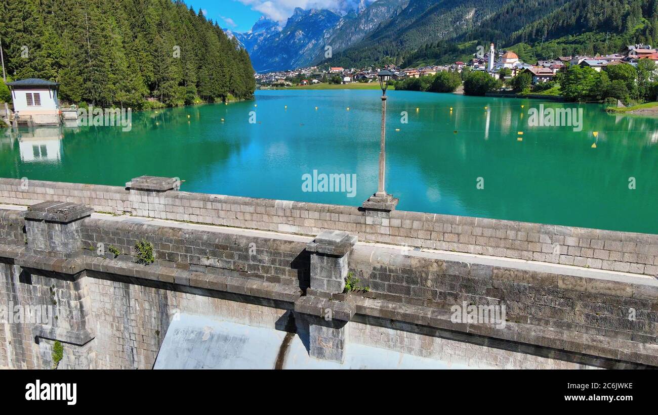 Alpin lake and dam in summertime, view from drone, Auronzo, italian dolomites. Stock Photo