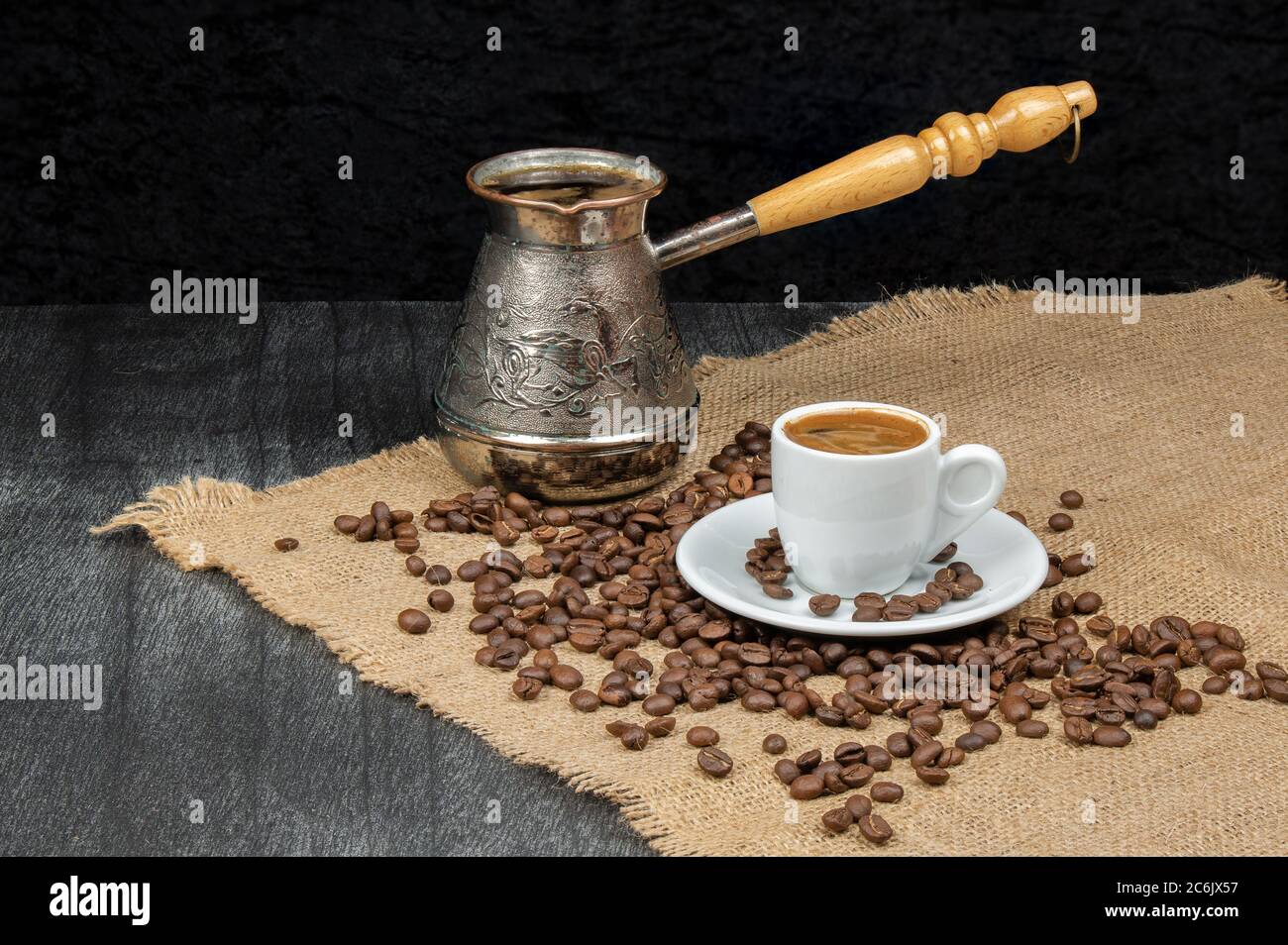https://c8.alamy.com/comp/2C6JX57/greek-coffee-in-white-small-mug-and-vintage-coffee-pot-turkish-coffee-cup-with-beans-on-wooden-background-coffee-culture-traditional-concept-copy-2C6JX57.jpg