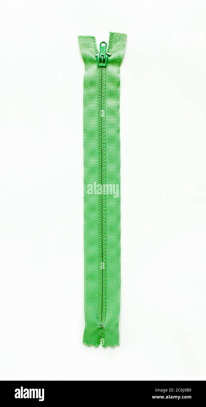 Green zipper isolated on white background. Stock Photo