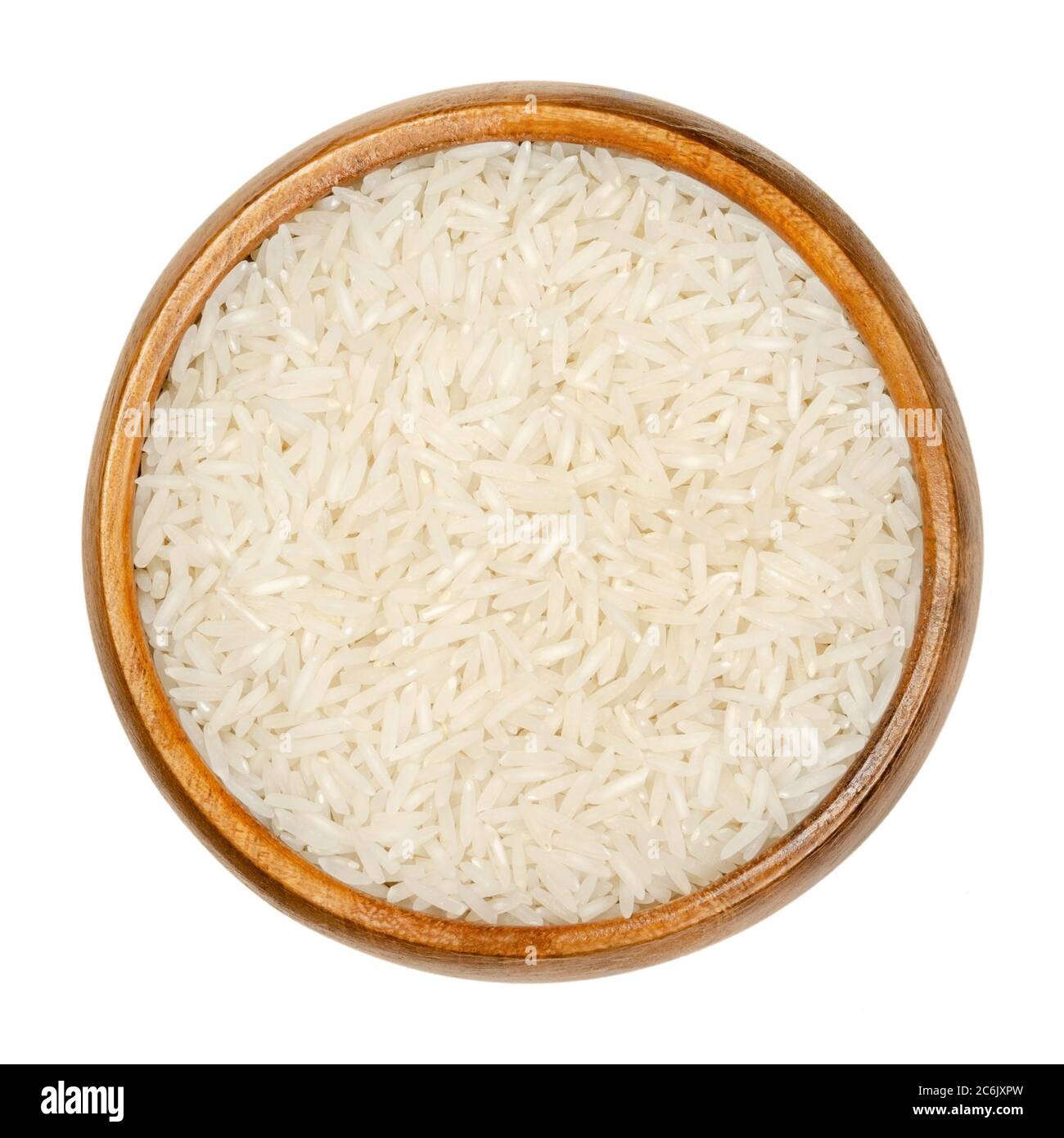 White Basmati rice in wooden bowl. Rice variety with long, slender grains and aromatic smell and taste, traditionally from Indian subcontinent. Stock Photo
