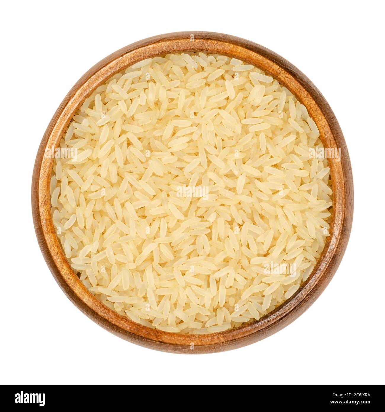 Parboiled long grain rice in wooden bowl. Converted rice also called