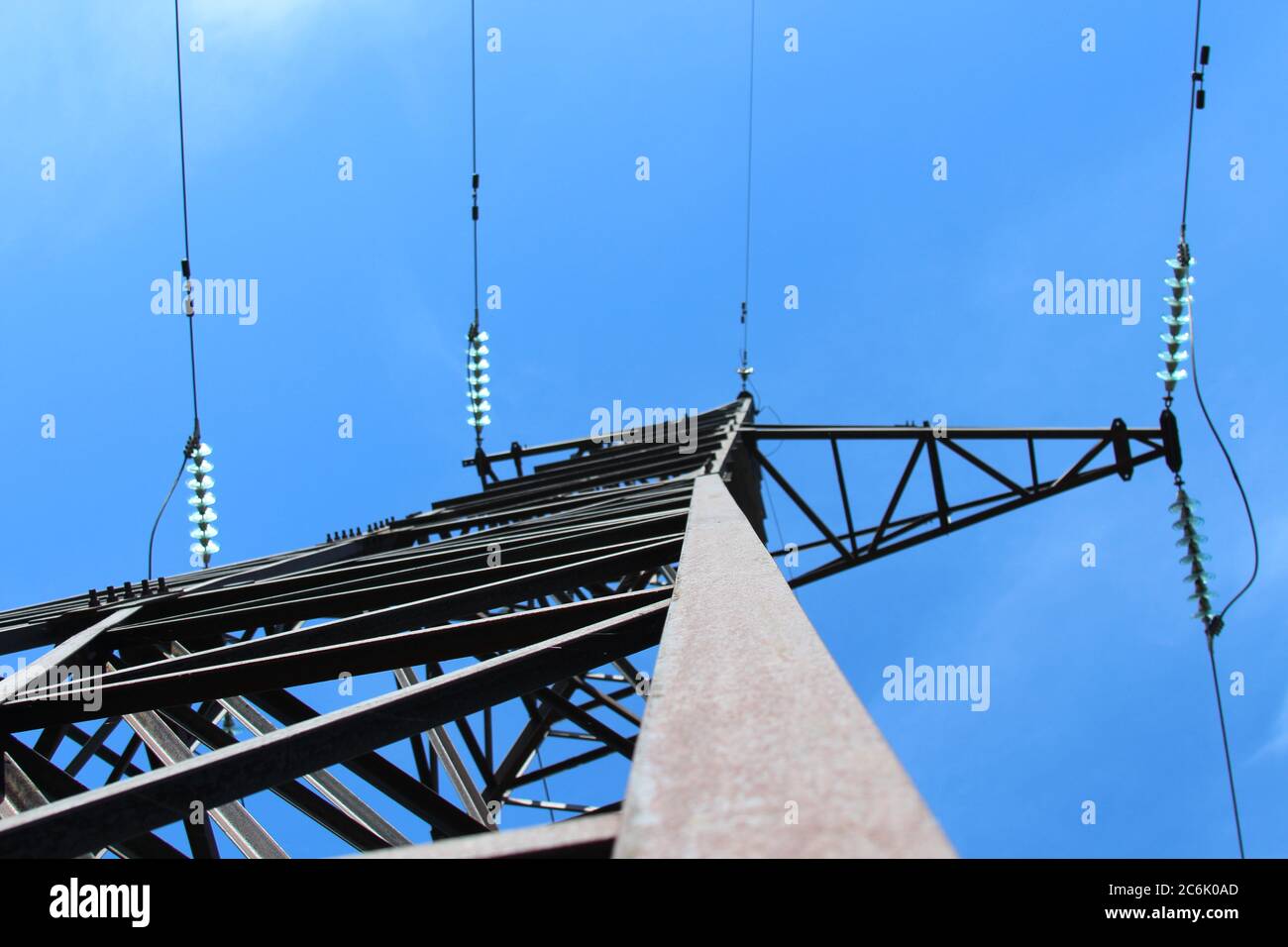 high voltage tower with wires against the blue sky, bottom view Stock ...