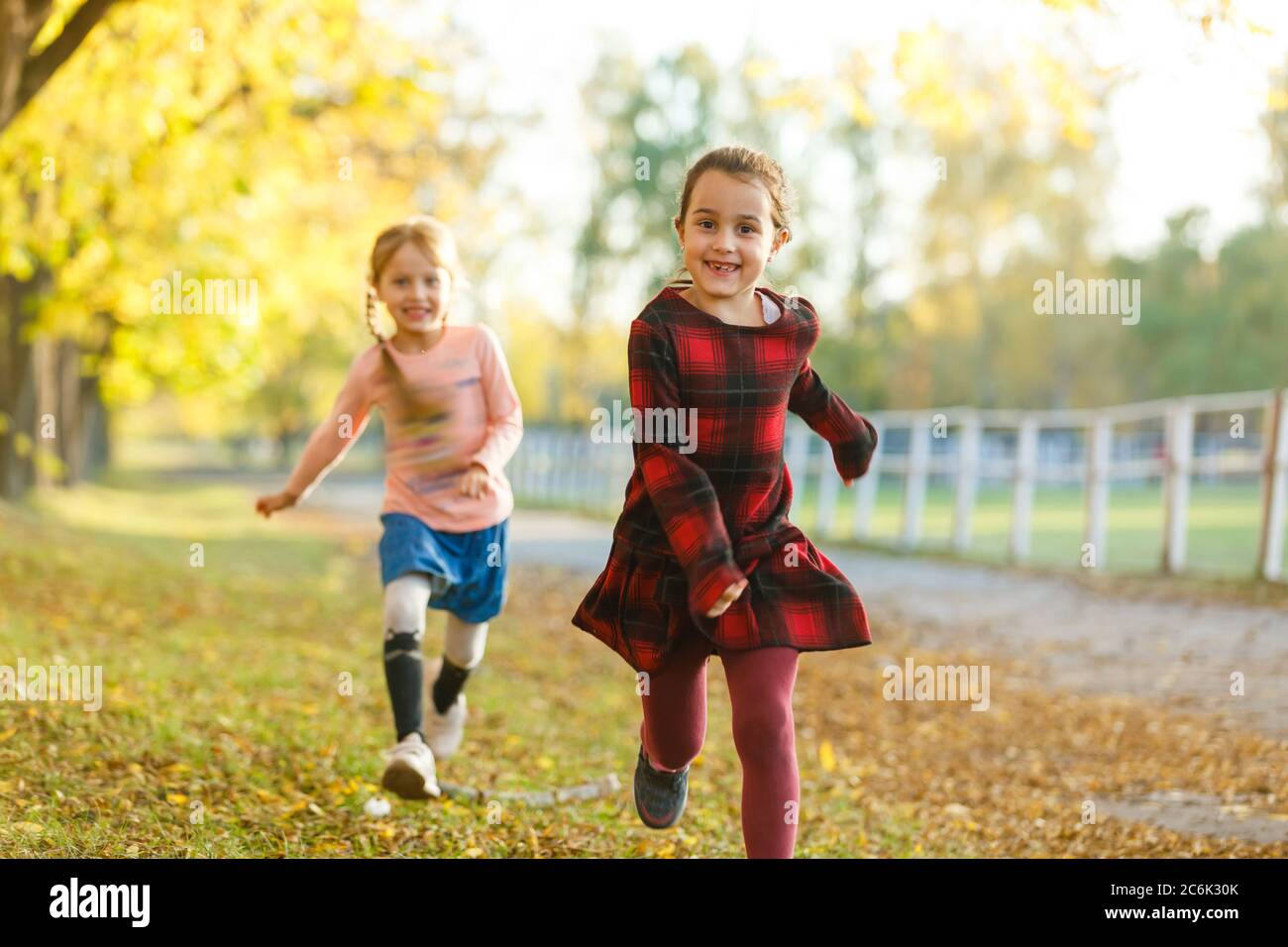 two girls in autumn park Stock Photo - Alamy