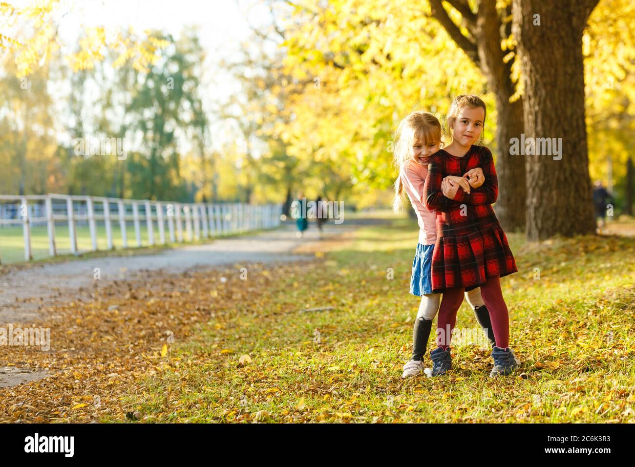 two little girls in autumn park Stock Photo - Alamy