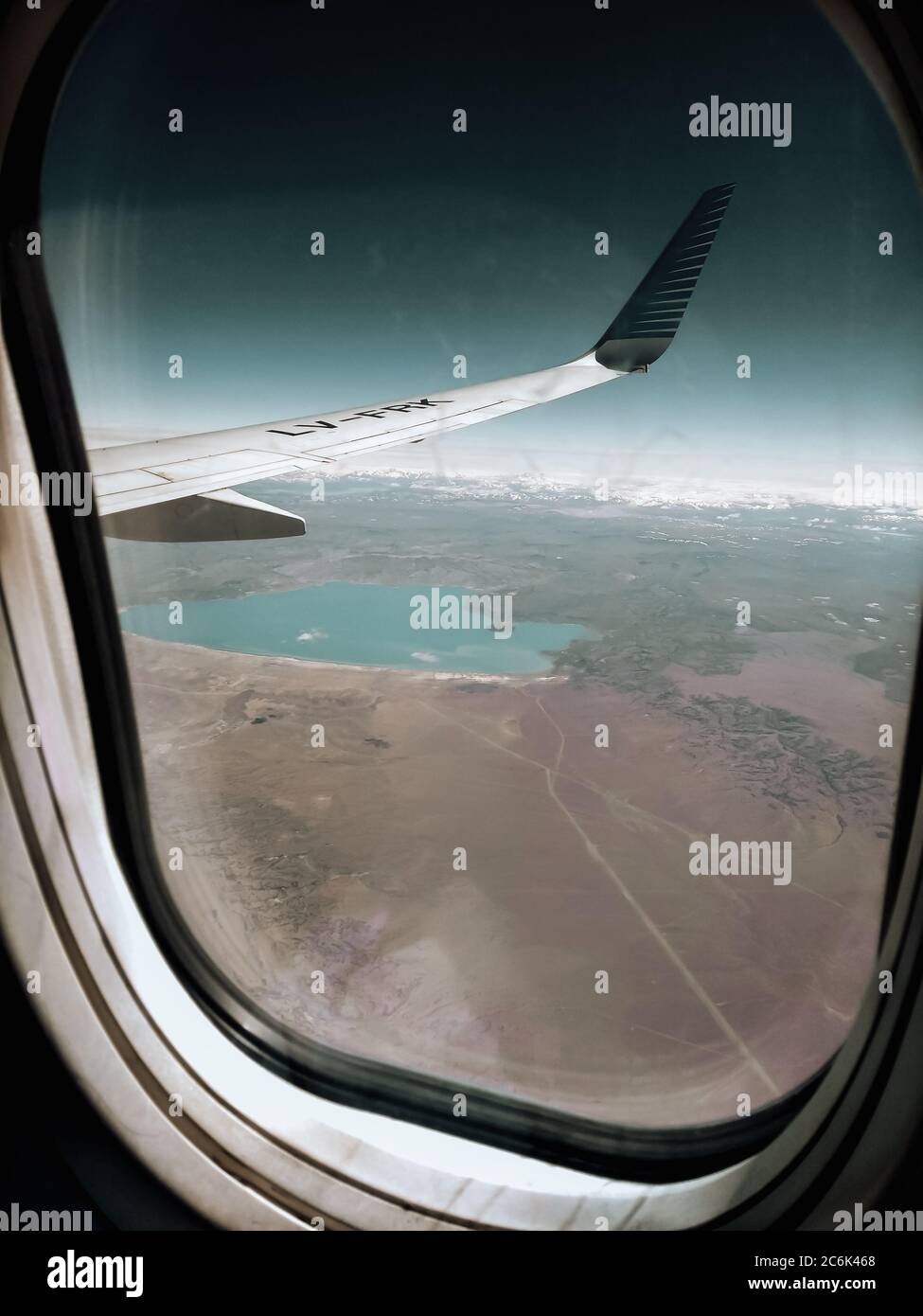 Aerial wing airplane. Views through the window of an airplane of the ...