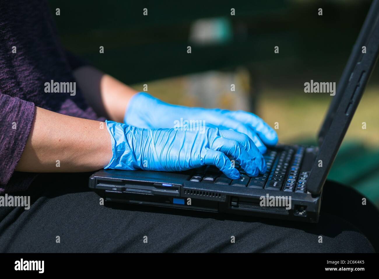 typing on notebook keyboard while wearing gloves Stock Photo Alamy