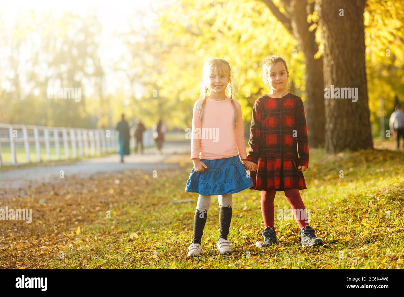 two little girls in autumn park Stock Photo - Alamy