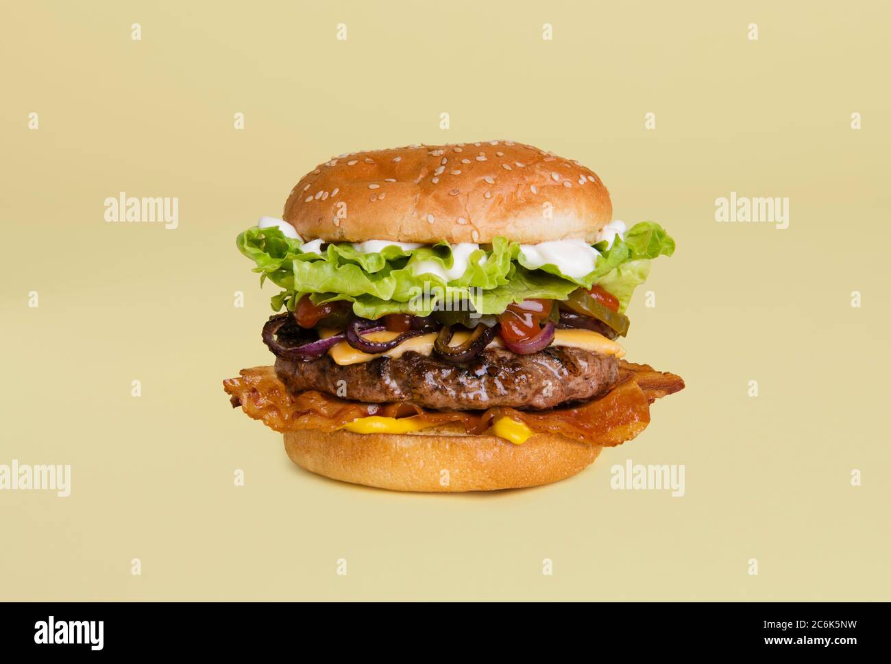 Bacon cheeseburger with onion, mustard, pickles, lettuce, ketchup and