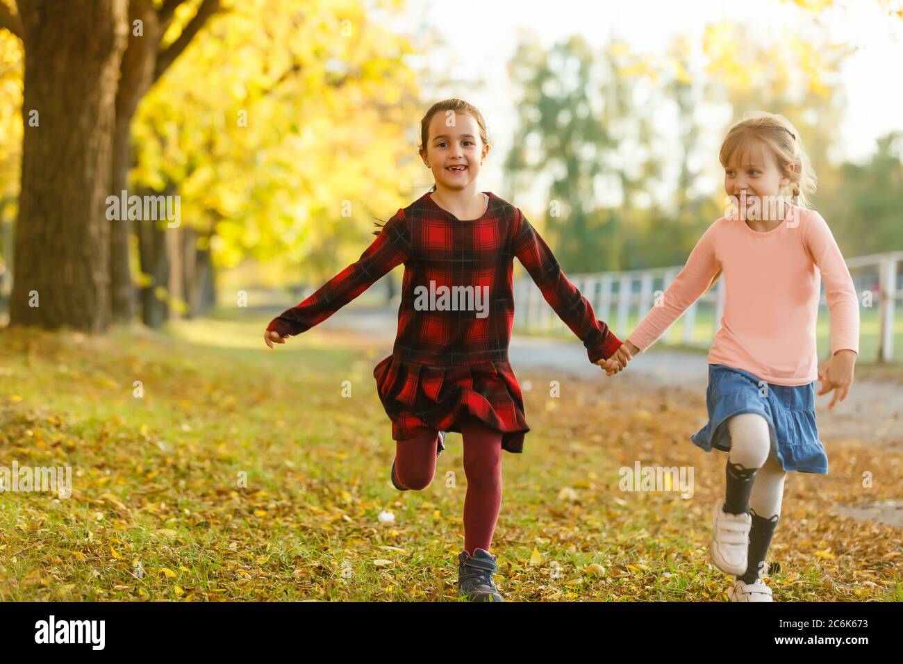 two girls in autumn park Stock Photo - Alamy